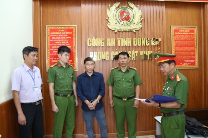 Cảnh sát đọc lệnh khởi tố Lợi. Ảnh: Thái Hà